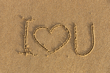 Fototapeta na wymiar I love you. The inscription is written in the sea sand..