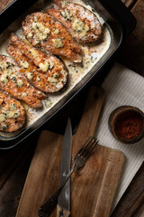 Salmon steak with creamy blue cheese sauce in a ceramic form. Restaurant food. Seafood. Rustic style. Flat Lay.