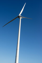 Modern windmill for electric power production with a clear blue sky in Arnhem in the Netherlands