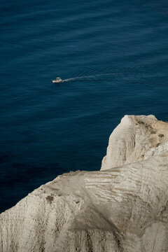 boat, sea and cliffs at Cape Aspro in Cyprus 