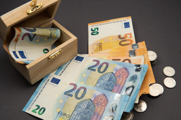 euro money in a box and coins