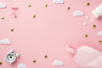 Fototapeta na wymiar Top view photo of small white alarm clock pink silk sleeping mask earplugs bottle with pills golden stars and clouds on isolated pastel pink background with blank space in the middle