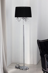 Electric black floor torshere stands on floor and fits perfectly into interior of room