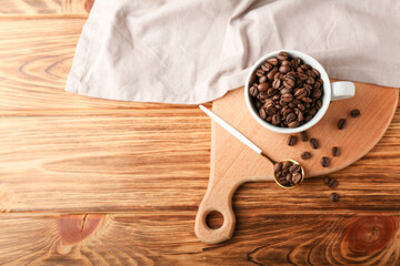 coffee beans in a cup with a teaspoon on a cutting board with a napkin and a wicker basket top view 