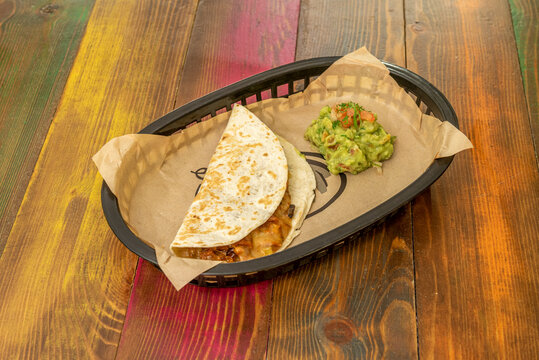 Gringas are a variety of tacos consisting of flour tortillas filled with cheese, al pastor meat, and pineapple. They are then grilled in the same way as a quesadilla