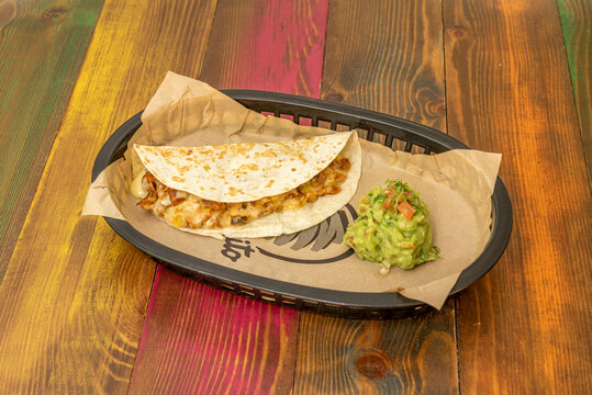 Gringas are a variety of tacos consisting of flour tortillas filled with cheese, al pastor meat, and pineapple. They are then grilled in the same way as a quesadilla