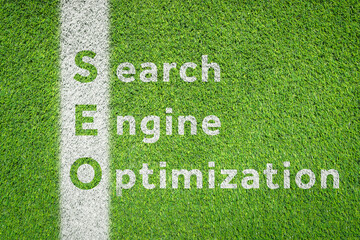 Search Engine Optimization (SEO) word on green artificial grass football (soccer) field textured...