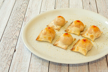 Ravioli, Italian pasta filled with different ingredients, usually folded into a square shape. They are accompanied by some type of sauce, especially tomato, tucos, pesto or creams