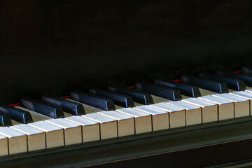 Black and white piano keys close-up. Black vintage grand pianoforte in the studio.