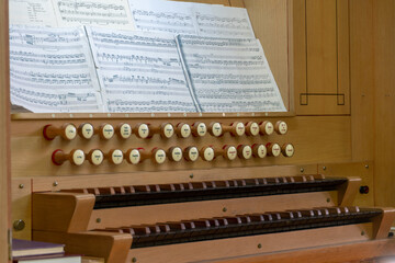 A large classical organ inside the Catholic Church.  a keyboard wind musical instrument. Organ keys...