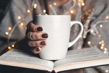 girl having a break with cup of fresh coffee after reading books or studying. manicure - 479219340