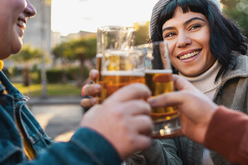 Group of happy friends drinking and toast beer at outdoors brewery restaurant