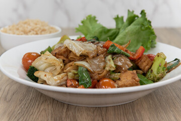 Pad kee mao authentic Thai food served with a side order of brown rice for a complete meal
