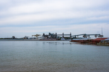 Industrial scene on the Mississippi River with grain elevator and barges