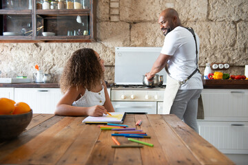 multiracial parental family sharing moments in the kitchen of their home