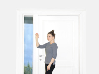 Fototapeta na wymiar Beautiful woman opening the door of her home.