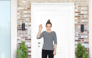 Beautiful woman opening the door of her home.
