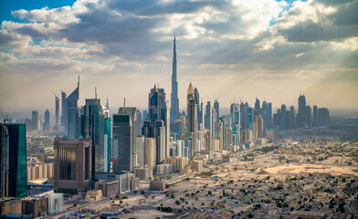 Aerial view of Downtown Dubai and city outskirts at sunset, view from helicopter.