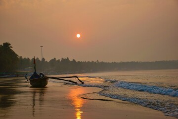 Fishing boat on the beach in the morning in Goa