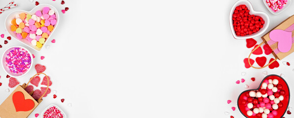 Valentines Day sweets double border with a variety of sweets. Overhead view on a white banner background with copy space.