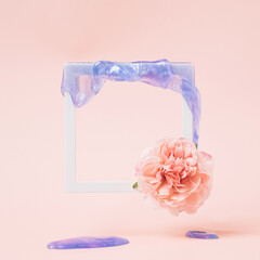 Romantic square frame with pink flower and violet slime dripping on a pastel pink background. Digital love conceptual background.