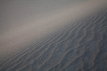 Abstract closeup of textures, patterns and ridges in the sand of dunes at Death Valley National...
