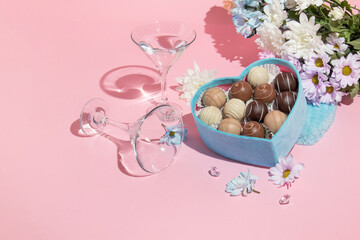 Valentines day creative layout with heart shaped blue chocolate box, flowers bouquet and martini...
