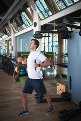 Man exercising in the gym on a pec deck machine for chest workout