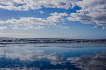 A glass-like beach and Pacific ocean