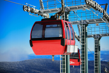 Easy way Gondola lift at Ski Resort. Beautiful winter sunny day with clean blue sky.