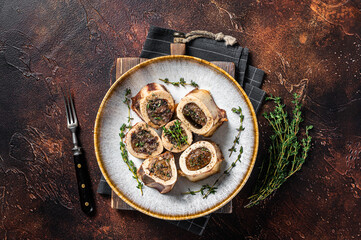 Baked marrow veal beef bones in plate with thyme and herbs. Dark background. Top view - obrazy, fototapety, plakaty