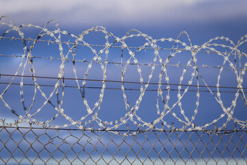 NATO barb wire with sharp and dangerous razor blades at a state border in europe	