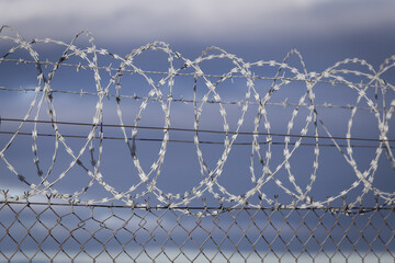 Closeup focus view of NATO barb wire with sharp and dangerous razor blades