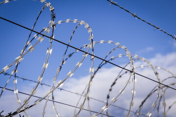 NATO barb wire with sharp and dangerous razor blades at a state border in europe	