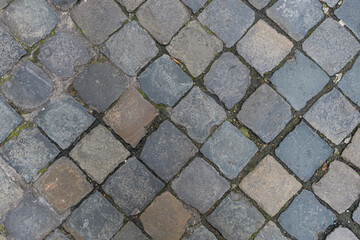 Paving slabs diagonally. The tiles are square-shaped, laid out diagonally. Street background motive