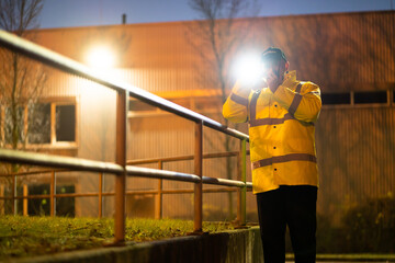 Security Guard Walking With Flashlight At Night