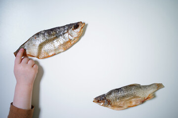 Dried fish on a white background, top view, copy space. High quality photo.