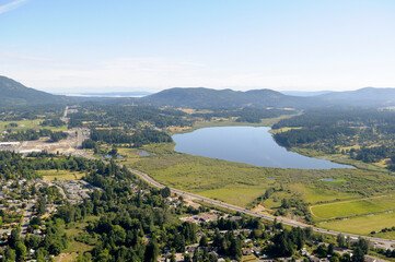 Aerial photo of Somenos Lake and the Trans Canada Highway, Cowichan Valley, Vancouver Island, British Columbia, Canada.