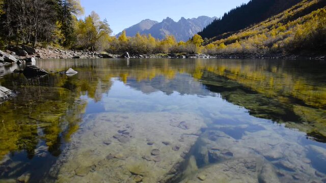 Alpine lake with clear transparent water in the autumn season in the morning