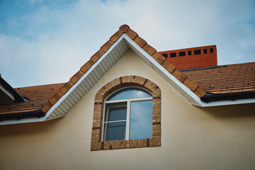attic window. modern chalet roof with attic windows. Window on the roof of the house