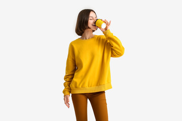 Beautiful woman with cup of coffee on light background