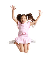 Adorable little girl in pink dress jumping on white background
