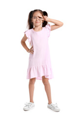 Adorable little girl in pink dress showing victory gesture on white background
