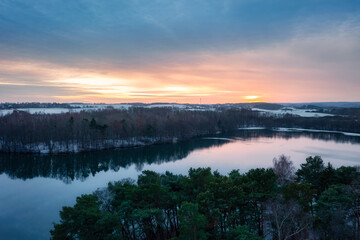 Aerial landscape of a wintery lake at sunset. Poland