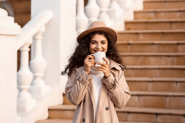 Fototapeta na wymiar Beautiful woman drinking tea outdoors