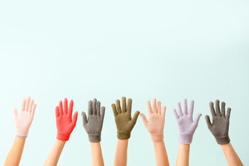 Women in warm gloves on blue background