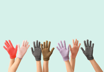 Women in warm gloves on blue background