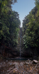 Spectacular forest waterfall surrounded with dense jungle.