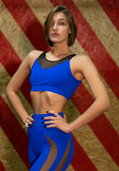 Naklejka premium Fitness woman in blue wear, trained female body, lifestyle portrait, caucasian model