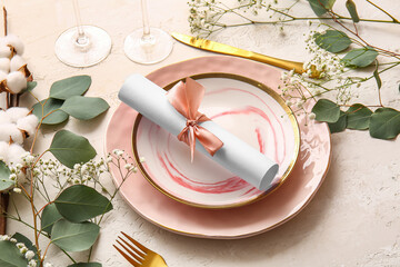 Beautiful table setting with wedding invitation on light background